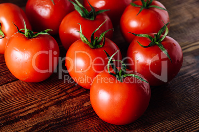 Some Red Tomatoes on Wooden Table