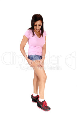 Slim woman checking her tights with her hands
