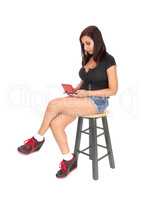 Woman sitting on chair, playing with her game
