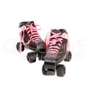 Two roller skates with black boots and pink laces