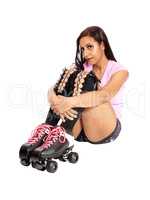 Roller skating woman sitting on the floor