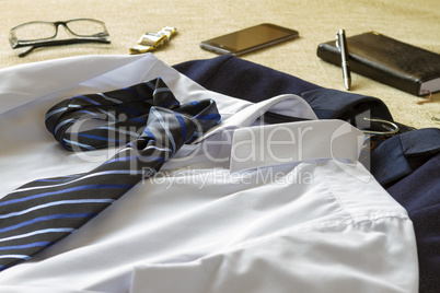 Business man clothes and accessories on bed