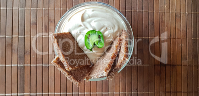 Fresh quark dip with herbs in a white bowl