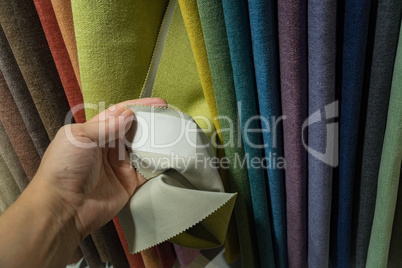 A young man examines the label on the fabric.