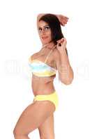Beautiful woman standing in a bikini in profile