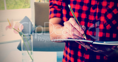 Composite image of hipster taking notes on notebooks