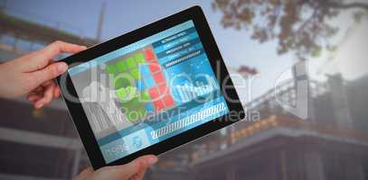 Composite 3d image of hands holding digital tablet against white background