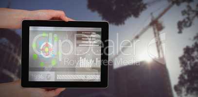 Composite 3d image of close-up of hands holding digital tablet