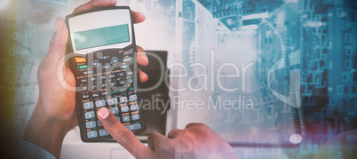 Composite image of cropped hands of businessman using calculator