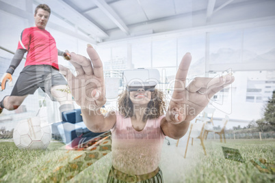 Composite image of female executive gesturing while using virtual reality headset