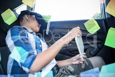 Boy with tablet using virtual reality headset in car