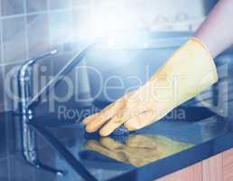 Cropped image of woman cleaning kitchen