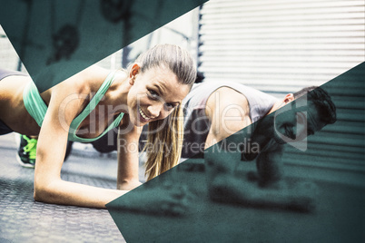 Muscular couple doing planking exercises