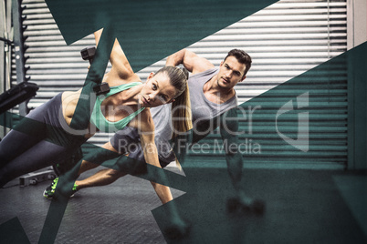 Smiling muscular couple doing side plank