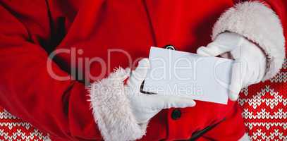 Composite image of midsection of santa claus holding blank placard