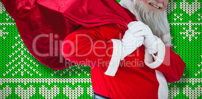 Composite image of santa claus holding christmas bag