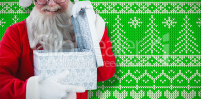 Composite image of santa claus opening a gift box