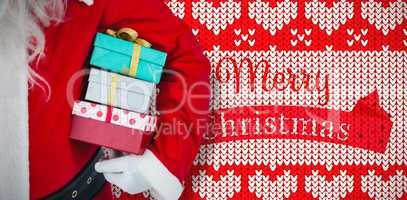 Composite image of santa claus holding gift boxes
