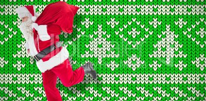 Composite image of santa claus walking with a sack