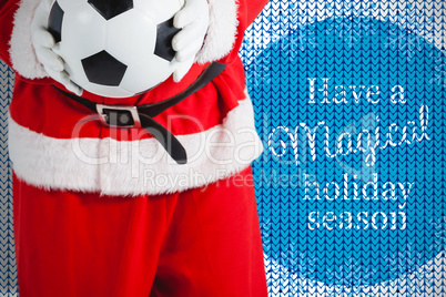 Composite image of santa claus holding football