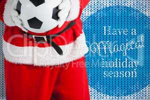 Composite image of santa claus holding football