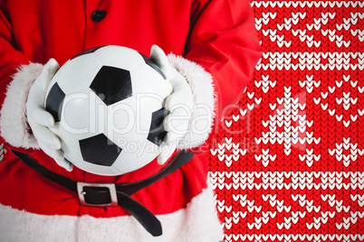 Composite image of santa claus holding a football