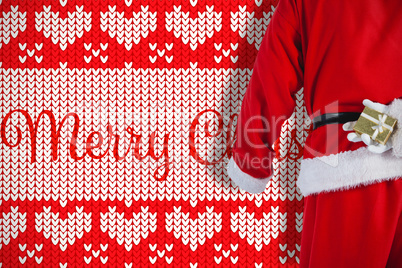 Composite image of santa clause holding a gift box behind his back