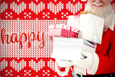 Composite image of santa claus holding gift boxes