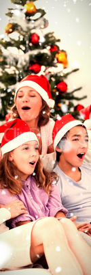 Composite image of extended family singing carols