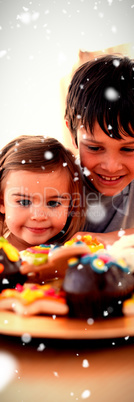 Composite image of brother and sister looking at confectionery