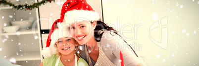 Composite image of portrait of a cute girl with her mother baking christmas cookies