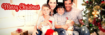 Composite image of happy family at christmas time holding lots of presents