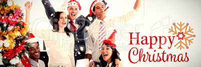 Composite image of nice business team punching the air to celebrate christmas