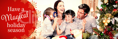 Composite image of happy family playing with christmas gifts