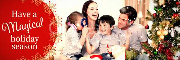 Composite image of happy family playing with christmas gifts