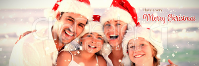 Composite image of family during christmas day at the beach