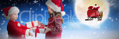 Composite image of cute siblings with gifts