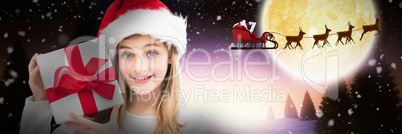 Composite image of portrait of smiling girl holding christmas gift against white background