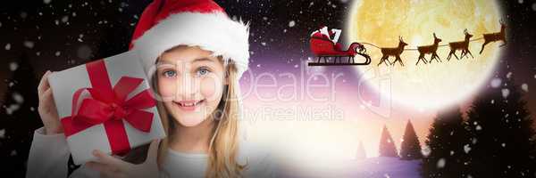 Composite image of portrait of smiling girl holding christmas gift against white background