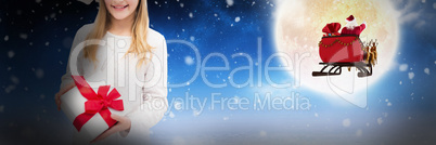 Composite image of portrait of happy girl holding christmas gift against white background