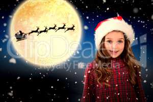 Composite image of cute girl in santa hat