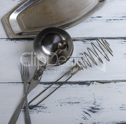 kitchen empty metal objects on a white wooden background