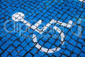 blue painted cobblestones, parking for handicapped