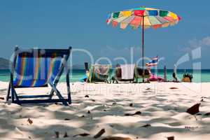 Beach umbrella and chairs in Komodo beach in Coral island, Thail