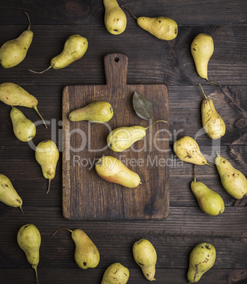 fresh ripe yellow pears on a brown wooden table