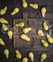 fresh ripe yellow pears on a brown wooden table