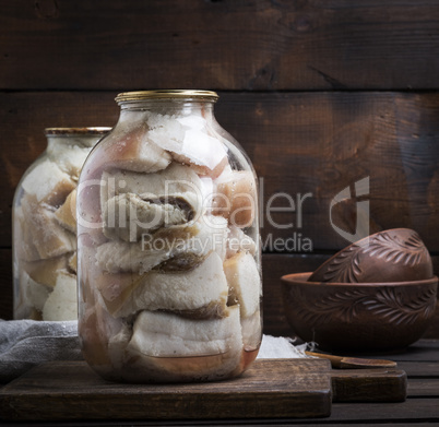salted pieces of lard with meat are closed in glass jars