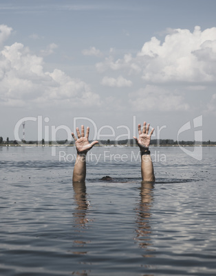 two male hands stick out of the water