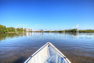 Kayak glides through water along the coastline of Marco Island,