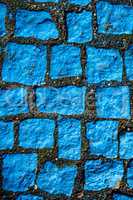 blue painted cobblestones, parking for handicapped